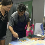 Art student at work and teacher